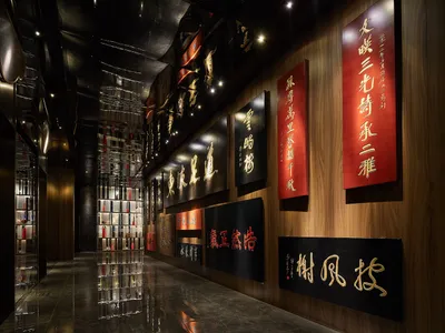 A modern restaurant corridor with metallic cladding and illuminated signage