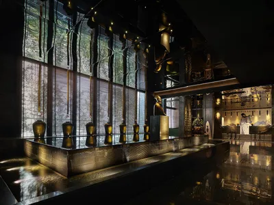 A modern hotel lobby with glass walls and decorations.