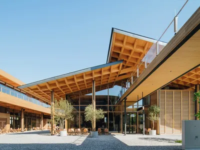 Modern exterior of a restaurant with wooden elements and a glass facade.