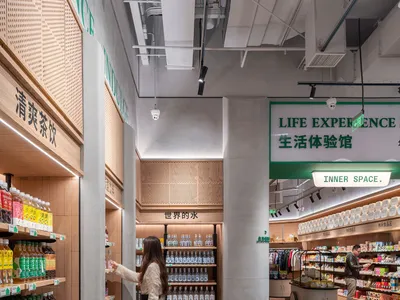 A photograph of a grocery store with concrete flooring and glass displays.