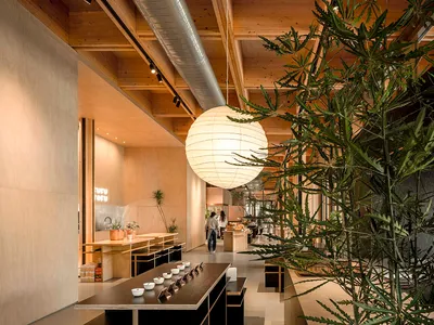 Modern restaurant interior with wooden counter and pendant lighting