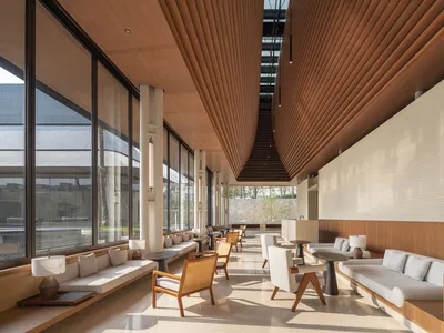 Modern minimalist hotel lobby featuring marble and wooden elements.