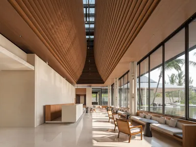 Modern hotel lobby featuring wood-tile ceiling and marble floor