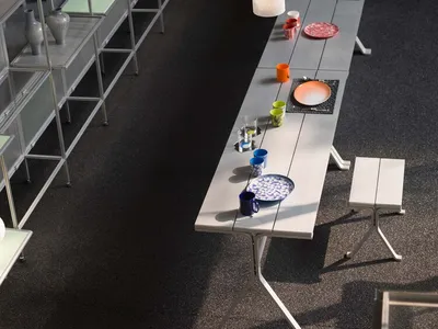 A modern restaurant interior featuring metal furniture and colorful tableware.