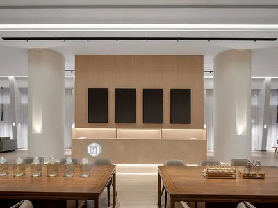 Modern hotel lobby featuring wooden accents and a minimalist design.