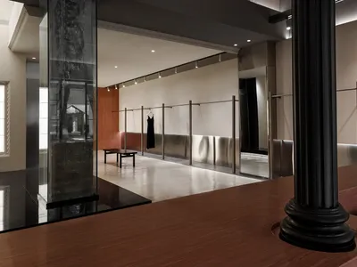極簡服飾零售店，配有金屬展示架與混凝土地板。