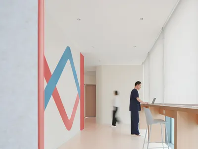 Minimalist design with white walls and red and blue patterns in a hospitality interior setting