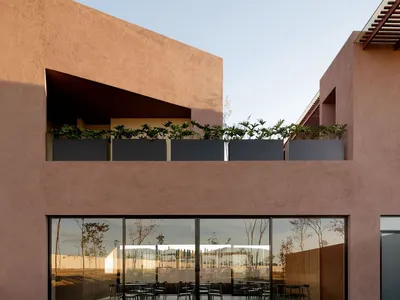 Modern restaurant interior with concrete walls and glass panels