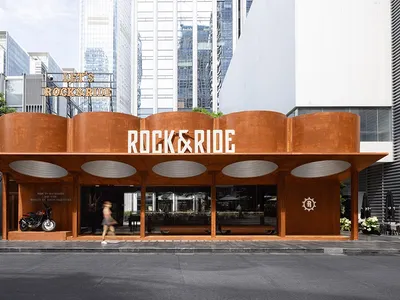Modern restaurant exterior with corten steel and concrete features.