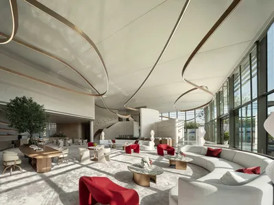 Modern hotel lobby with white furniture and glass walls