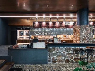 Modern restaurant interior with stone, wood, and metal materials.