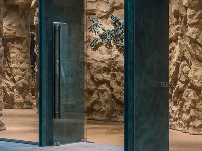 現代店面入口採用玻璃材質，石材牆面搭配 Arc'teryx 發光標誌。