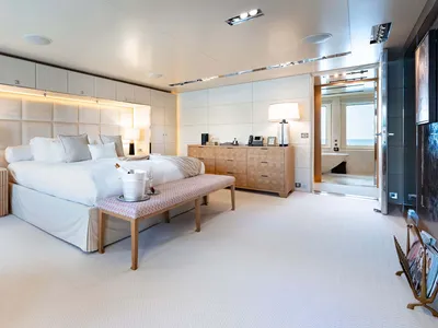 Modern, minimalist bedroom with neutral tones and contemporary fixtures.