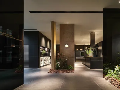 A modern kitchen with stone countertops and flooring.