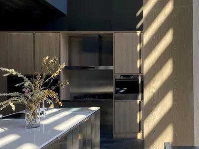 Contemporary kitchen featuring wooden cabinetry and stainless steel appliances