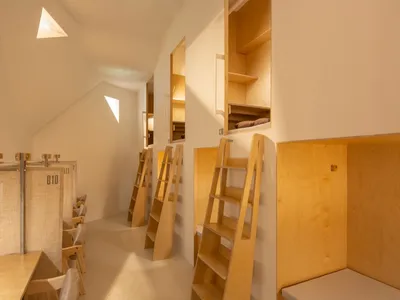 Minimalist bedroom with wooden shelves and bunk beds