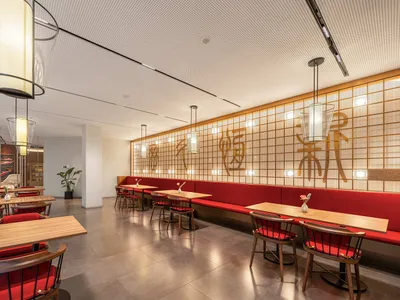 現代餐廳室內，配有紅色絨布座椅與木製餐桌。