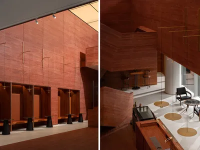 Modern restaurant interior featuring red marble walls and furniture