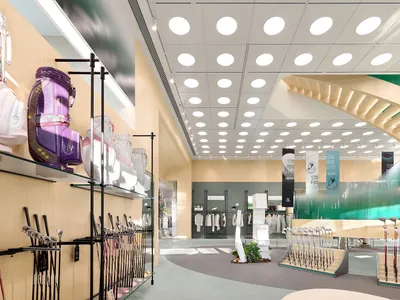 一間燈光明亮的零售店室內空間，採用玻璃與金屬材質，陳列高爾夫球袋、球桿及服飾。