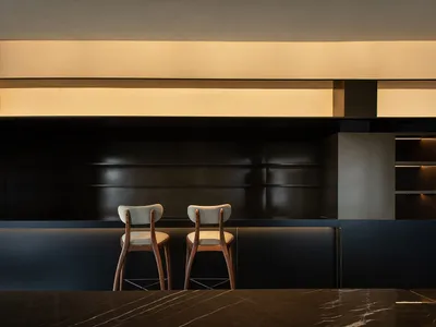 Modern bar area featuring marble and glass materials, designed for retail settings.