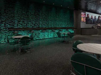 A modern restaurant bar with a textured concrete ceiling and green lighting.