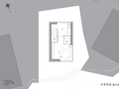 混凝土衛浴套房平面圖，配有圓形浸泡浴缸與相鄰的盥洗室。