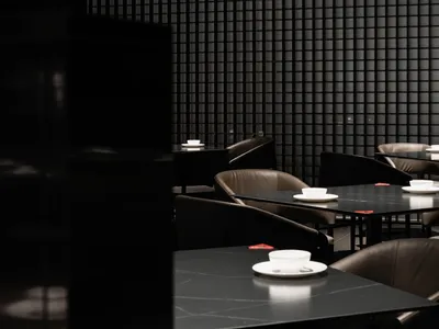 Minimalist restaurant interior with black and glass design elements.