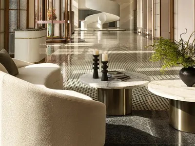 Modern hotel lobby featuring marble and concrete materials.