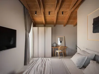Modern minimalist bedroom featuring wood-paneled ceiling, fabric bedding, and metal accents.