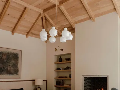 A minimalist bedroom with wood elements and a fireplace.