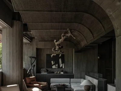 A living room with industrial design features, concrete materials, and minimalist furniture.