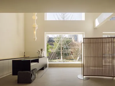 Modern minimalist kitchen featuring wood and concrete materials.