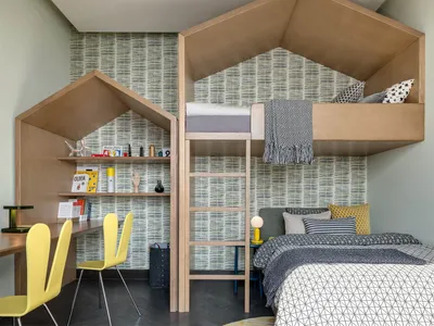 A modern children's bedroom featuring a wooden bunk bed with a roof and built-in shelves.