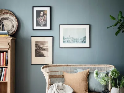 A cozy industrial-style living room featuring a rattan sofa and wooden furniture.