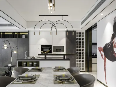 Modern kitchen with marble countertops, glass cabinets, and a white center island.