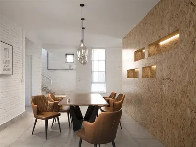 An industrial-style restaurant interior featuring brick, concrete, oriented strand board (OSB), and leather furniture.