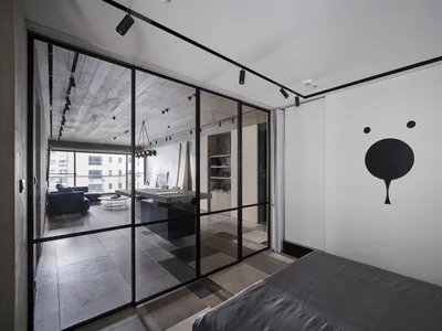 Modern bedroom with concrete floor and minimalist design.