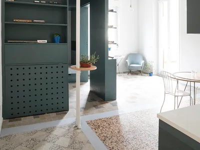 Modern home office featuring a concrete wall and floor, with a minimalist design.