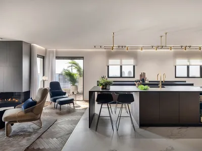 Contemporary kitchen interior with marble countertops, modern lighting, and minimalist design.