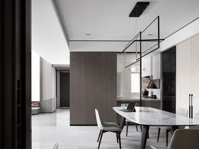 A modern kitchen-dining space featuring marble countertops and wooden accents.