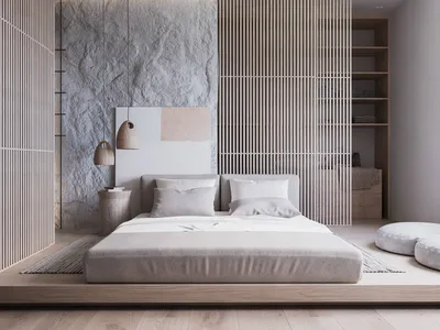 A minimalist bedroom featuring concrete and wood materials with a low-profile bed and hanging lamps.