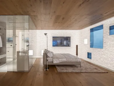Modern bathroom and bedroom with wooden floors and walls.