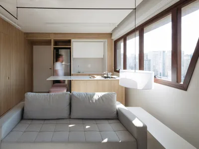 Minimalist residential kitchen featuring wood and glass elements.