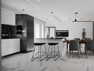 Modern residential kitchen with marble countertops and white walls