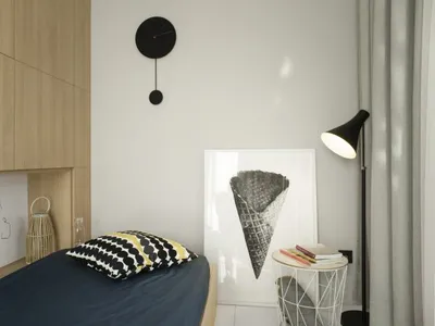 Modern minimalist bedroom featuring a single bed adorned with a black and yellow polka dot pillow against a black and white i