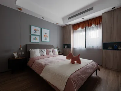 A minimalist bedroom with mixed materials, featuring gray walls, wooden floors, and a bed with pink and white bedding.