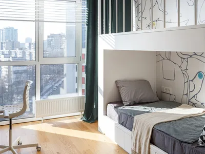 Minimalist bedroom with a white bunk bed, wooden floor, and large window.