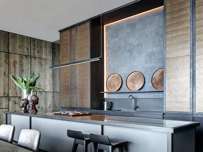 A modern kitchen featuring a kitchen island with a modern design and white and black countertop, surrounded by wooden cabinet