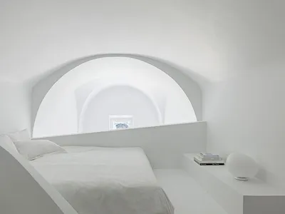 一間簡約風格的臥室，擁有白色牆面、白色床鋪與白色床頭櫃。