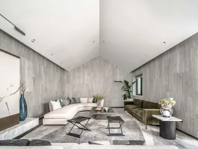 現代極簡客廳，混凝土牆面與地板，搭配白色L型沙發及綠色室內植物。